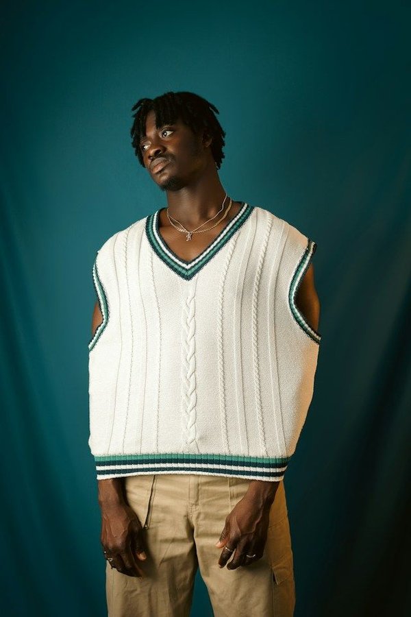 How can you style a sweater vest for a trendy look?